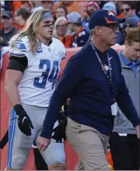  ?? DAVID ZALUBOWSKI — THE ASSOCIATED PRESS ?? Detroit Lions inside linebacker Alex Anzalone, left, who is tied for the team lead in tackles, walks off the filed after suffering an ankle injury during Sunday’s road loss to the Denver Broncos.