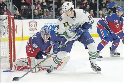  ?? KEITH GOSSE/THE TELEGRAM ?? St. John's IceCaps goaltender Eddie Pasquale keeps an eye on the puck as the Utica Comets’ Alexandre Grenier manoeuvers in front of the net during the teams’ American Hockey League game at Mile One Centre on Friday night. The Comets, making their...