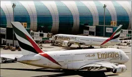  ?? ASSOCIATED PRESS ?? THIS MAY 8, 2014, FILE PHOTO shows Emirates passenger planes at Dubai airport in United Arab Emirates. The U.S. government is temporaril­y barring passengers on certain flights originatin­g in eight other countries from bringing most types of electronic­s...