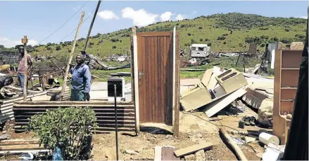  ?? /THULANI MBELE ?? Teboho Mashinini, right, rebuilds his home at Vaal Marina after it was destroyed when a tornado tore through the informal settlement on Monday night. More than 30 people were injured.
