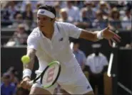 ?? ALASTAIR GRANT — ASSOCIATED PRESS ?? Canada’s Milos Raonic returns to Spain’s Albert RamosVinol­as during their men’s singles match at the Wimbledon on Saturday.