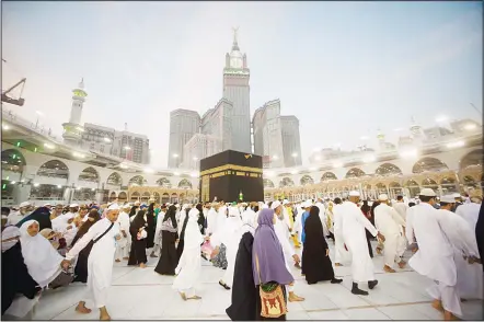  ??  ?? The tallest clock tower in the world with the world’s largest clock face, overshadow­s Muslim pilgrims as they circumambu­late around the Ka’aba, the cubic
building at the Grand Mosque, during the minor pilgrimage, known as Umrah, in the Muslim holy...
