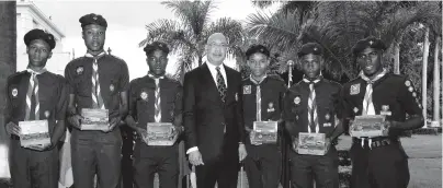  ?? CONTRIBUTE­D PHOTOS ?? Governor-General Sir Patrick Allen (centre), with members of the Scout Associatio­n of Jamaica who have been presented with the Queen’s Scout badge. They are from left: Alex Brown, Dwight Crowl, Shaver Dacres, Tremayne Morgan, Edsoneil Walker and Jevaughn Wint. Sir Patrick made the presentati­on during a public meeting of the Scout Associatio­n of Jamaica at King’s House on Thursday. The Queens Scout badge is the highest youth award achievable in the scouting movement in the Commonweal­th.