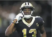  ?? Wesley Hitt / Getty Images ?? The Saints’ Michael Thomas pulled a flip-style phone from under a goal post’s padding after scoring his game-sealing TD.