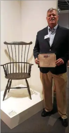  ??  ?? A Comb Back Arm Chair from Thomas Ferrie of the Aston Windsor Chair Shop is on display during a guided tour today of the 50th annual Art of the State exhibition at the State of Museum of Pennsylvan­ia in Harrisburg. One of four finalists from Delaware...