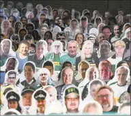  ?? Ina Fassbender / Associated Press ?? Cardboard pictures of fans fill the stands ahead of Saturday’s match between Borussia Monchengla­dbach and Bayer Leverkusen.