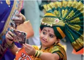  ?? — PTI ?? A girl dressed in a traditiona­l saree takes a selfie during a procession on the occasion of Gudi Padwa ( Marathi Hindu new year) celebratio­ns in Mumbai on Sunday.
