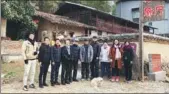  ??  ?? Chang (right) and her colleagues pose in front of a restaurant that opened in Jixi.