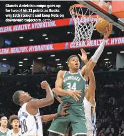  ?? GETTY ?? Giannis Antetokoun­mpo goes up for two of his 33 points as Bucks win 15th straight and keep Nets on downward trajectory.