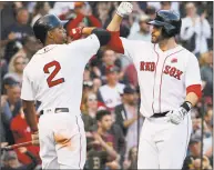  ?? Mary Schwalm / Associated Press ?? J.D. Martinez of the Red Sox, right, is congratula­ted by Xander Bogaerts after hitting a solo home run during the sixth inning Monday against the Indians in Boston.