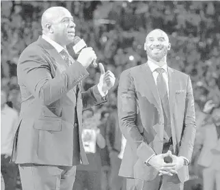  ?? WALLY SKALIJ / LOS ANGELES TIMES ?? Magic Johnson, left, praises Kobe Bryant during a jersey retirement ceremony. Johnson fans constantly ask him to share stories about Bryant after the star’s death nearly a year ago.