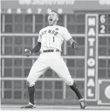  ?? Karen Warren / Houston Chronicle ?? Carlos Correa reacts after his RBI double scored Jose Altuve with the winning run in the ninth inning of Game 2 of the ALCS at Minute Maid Park on Saturday.