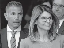  ??  ?? In this April 3, 2019, photo, actress Lori Loughlin, front, and husband, clothing designer Mossimo Giannulli, left, depart federal court in Boston after facing charges in a nationwide college admissions bribery scandal. [STEVEN SENNE/ASSOCIATED PRESS FILE PHOTO]