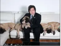  ?? (The New York Times/Marcelo Dubini/Caras) ?? Javier Milei, a far-right politician who might soon be Argentina’s next president, is shown at home with his cloned mastiff puppies in 2018.