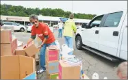  ?? Leslie Hutchison / Hearst Connecticu­t Media ?? Volunteers arrived at 7 a.m. on Tuesday to organize donations for 800 families in the region. The “Feed the Children” event was the first held in Torrington.