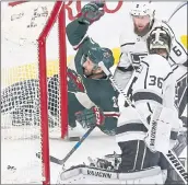  ?? JIMMONE — THE ASSOCIATED PRESS ?? Eric Fehr, left, scored his first goal this season to help the Wild beat the Kings for its fourth straight win.