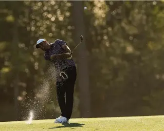  ?? Robert F. Bukaty / Associated Press ?? Scottie Scheffler hits on the 14th fairway during the final round at the Masters tournament. Scheffler joined Ian Woosnam in 1991 as the only players to win a major in their debut at No. 1.