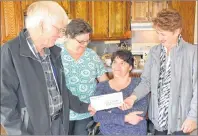  ?? ERIC MCCARTHY/JOURNAL PIONEER ?? Martin MacRae, Grand Knight of the Rev. P. Walsh Council 8966 Palmer Road Knights of Columbus, presents Janie McRae, right, a member of the Lisa Doucette Van Fund Committee with a $1,000 contributi­on to be put towards the purchase of a wheelchair...