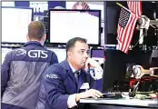  ??  ?? Specialist Dilip Patel, (right), works on the floor of the New York Stock Exchange, Oct 2. US stocks turned positive in choppy trading on Thursday as US
services sector activity slowed to a three-year low.
(AP)