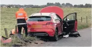  ??  ?? PROBE Crash investigat­ors with Citroen car at scene