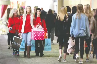  ?? STAFF FILE PHOTO BY ERIN O. SMITH ?? Shoppers walk through Hamilton Place mall during this year’s Black Friday. The mall will enforce a policy the day following Christmas that requires any mall patron under the age of 18 to be accompanie­d by an adult 21 years or older.