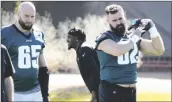  ?? MATT YORK/AP ?? PHILADELPH­IA EAGLES CENTER Jason Kelce (62) and offensive tackle Lane Johnson (65) warm up during a Super Bowl team practice on Wednesday in Tempe.