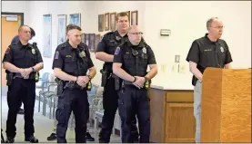  ?? / Adam Cook ?? Fort Oglethorpe officials were introduced to new officers during the March 11 City Council meeting. From left: Lt. Shane Fann, officers Ethan Sarrell, Marcus Alford, Justin Ruth, and Chief Mike Helton (at the podium).