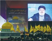  ?? (Aziz Taher/Reuters) ?? HEZBOLLAH CHIEF Hassan Nasrallah addresses supporters via video link during a rally marking al-Quds Day in South Beirut on Friday.