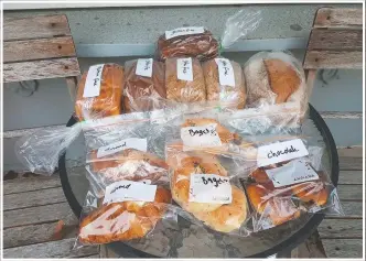  ??  ?? Freshly baked loaves of bread and pastries sit outside Everett’s home.