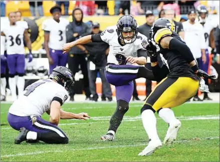  ?? JUSTIN BERL/GETTY IMAGES/AFP ?? Justin Tucker of the Baltimore Ravens kicks the game winning 46-yard field goal in overtime during the game against the Pittsburgh Steelers at Heinz Field on Sunday in Pittsburgh, Pennsylvan­ia.