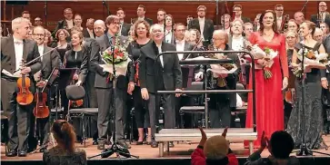  ?? NZSO ?? NZSO music director and conductor Edo de Waart is at front centre, with Swedish mezzo-soprano Anna Larsson in red, and American soprano Lauren Snouffer to the right of De Waart.