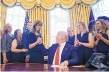  ?? CAROLYN KASTER/ASSOCIATED PRESS ?? President Donald Trump shakes hands with Tammie Jo Shults in the Oval Office of the White House on Tuesday as he meets with crew members and passengers from Southwest Airlines Flight 1380.