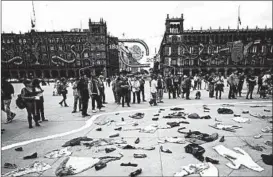  ?? PEDRO PARDO/GETTY-AFP ?? People surround an installati­on Tuesday in Mexico City to mark the 1968 massacre of students by soldiers in Tlatelolco plaza. It is unclear how many died; estimates range from an official count of 25 to a more recent probe that named 44.