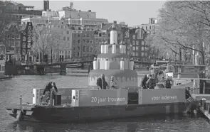  ?? PETER DEJONG/AP ?? An inflatable cake glides through Amsterdam’s canals Thursday, the 20th anniversar­y of the world’s first legal same-sex marriages.