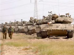  ??  ?? Israeli Merkava tanks are seen stationed in an open area near Israel’s border with the Gaza Strip after Hamas pledged to launch an investigat­ion into rocket fire at Israel earlier this week, in an apparent bid to calm fears of a new war. — AFP photo