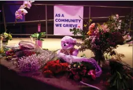  ?? RAY CHAVEZ — BAY AREA NEWS GROUP ?? A tribute banner is displayed along with seven candles and flowers in a makeshift memorial to honor mass shooting victims at Mac Dutra Park in Half Moon Bay. Seven adults were killed by one suspect at two different locations.