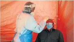  ?? Picture: Phill Magakoe ?? City of Tshwane health-care workers conduct mass Covid-19 testing in East Lynn, Pretoria. The National Health Laboratory Service says there is a ‘lot of confusing messaging’ about when testing should be done.