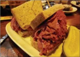  ??  ?? MARK KOESTNER — FOR THE NEWS-HERALD The standard-sized corned beef sandwich at Slyman’s Tavern will set you back about $15, but it’s a monster that likely will leave you with a leftovers meal.