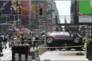  ?? MARY ALTAFFER — THE ASSOCIATED PRESS ?? A car rests on a security barrier in New York’s Times Square after driving through a crowd of pedestrian­s. A three-foot-tall piece of stainless steel in the ground stopped a speeding Honda as it barreled down the crowded sidewalks of Times Square. The...