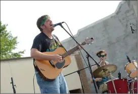  ?? NWA Democrat-Gazette/BEN GOFF • @NWABENGOFF ?? Justin Collier (left) and Tanner Mackey play with their band Surfers of the Omniverse from Springdale in the battle of the bands on Shiloh Square.