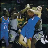  ?? ROD AYDELOTTE — THE ASSOCIATED PRESS ?? Kansas’ Mitch Lightfoot, right, pulls down a rebound over Baylor’s Adam Flagler in the first half of Monday’s Big 12 contest. Second-ranked Baylor won 77-69.