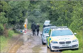  ??  ?? Police at the murder scene in woods six miles from Mr Wrighton’s home