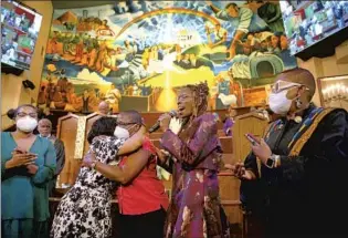  ?? Gary Coronado Los Angeles Times ?? PASTOR Thema Bryant, second from right, also a professor of psychology at Pepperdine, prays for Debra Lumpkin, second from left, hugging her sister Dorothy Banks, at First AME Church in L.A.