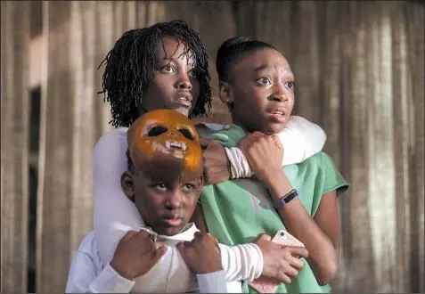  ??  ?? Adelaide Wilson (Lupita Nyong’o) protects her children Jason (Evan Alex) and Zora (Shahadi Wright Joseph) from sinister invaders in Jordan Peele’s