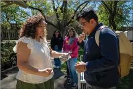  ?? PHOTO BY JOSÉ LUIS VILLEGAS FOR CALMATTERS ?? Carlos Morales and Michelle Villegas-Frazier participat­e in a sage burning ritual outside of the Native American Academic Student Success Center at UC Davis on April 1, 2024.