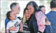 ?? RICH PEDRONCELL­I / ASSOCIATED PRESS ?? Salena Manni (center), fiancee of police shooting victim Stephon Clark, holds their son Aiden at a protest on Saturday in Sacramento, California.