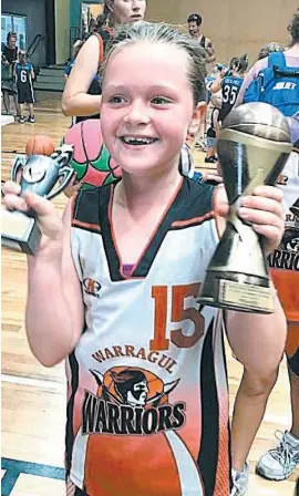  ??  ?? Meg Cooper shows off her trophies after winning the under 10 title at Traralgon.