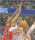  ?? PHIL LONG/AP PHOTO ?? The Cavaliers’ LeBron James broke Michael Jordan’s NBA record Friday by scoring at least 10 points in his 867th straight regular-season game, against the Pelicans in Cleveland.