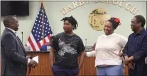  ?? PETE BANNAN-DAILY TIMES ?? Darby Mayor Darren Burrell presents Cameron Payne, 11, with the certificat­e of appreciati­on on Wednesday night. With them are Cameron’s parents, Lakeita Payne and Randy Hooks.