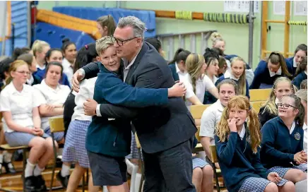  ?? ROBYN EDIE/STUFF 635003791 ?? Northern Southland College year 8 student Nicholas Sim hugs Sir John Kirwan at a full school assembly yesterday after Kirwan asked the students to all hug someone they ordinarily wouldn’t.